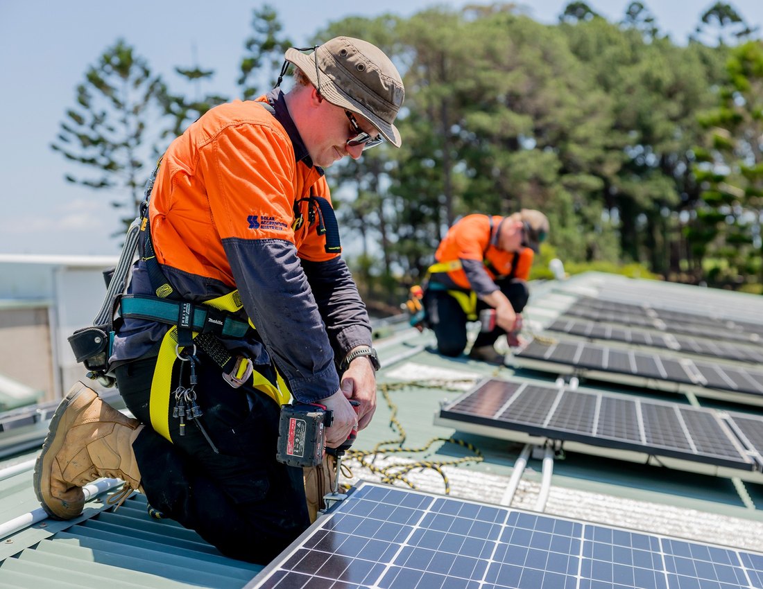 Solar installation team working on a commercial rooftop array
